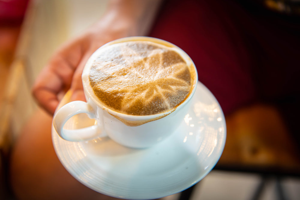 A CBD latte with a hemp leaf in the foam.