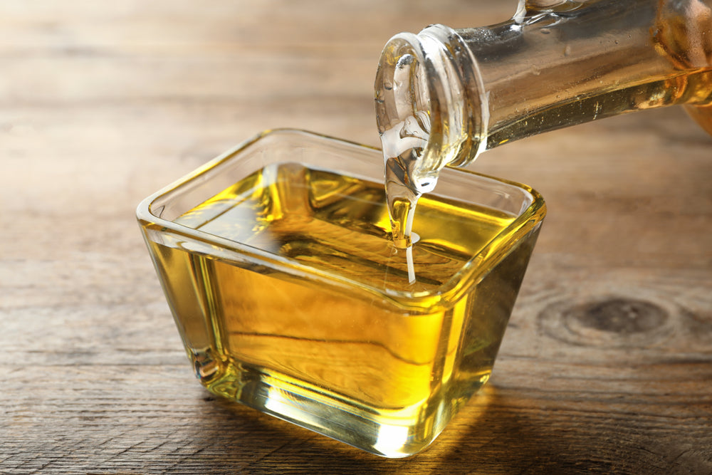 Canola oil is poured into a bowl.