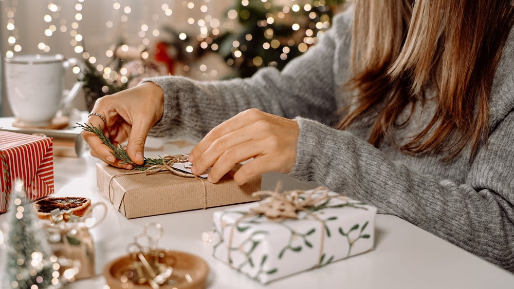 Woman wraps holiday gifts. 