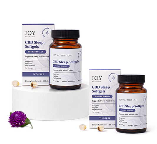 Two amber bottles and two white boxes of CBD Sleep Softgels with softgel capsules displayed in front.