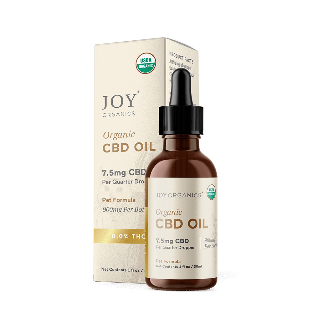 Joy Organics organic CBD oil tincture in amber glass bottle with dropper next to cream-colored box packaging.